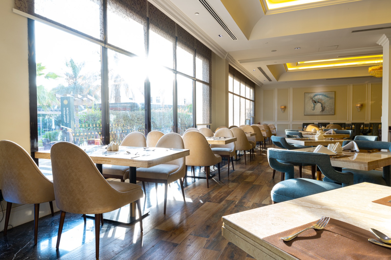 The restaurant's window wall, its tables laid beside the garden