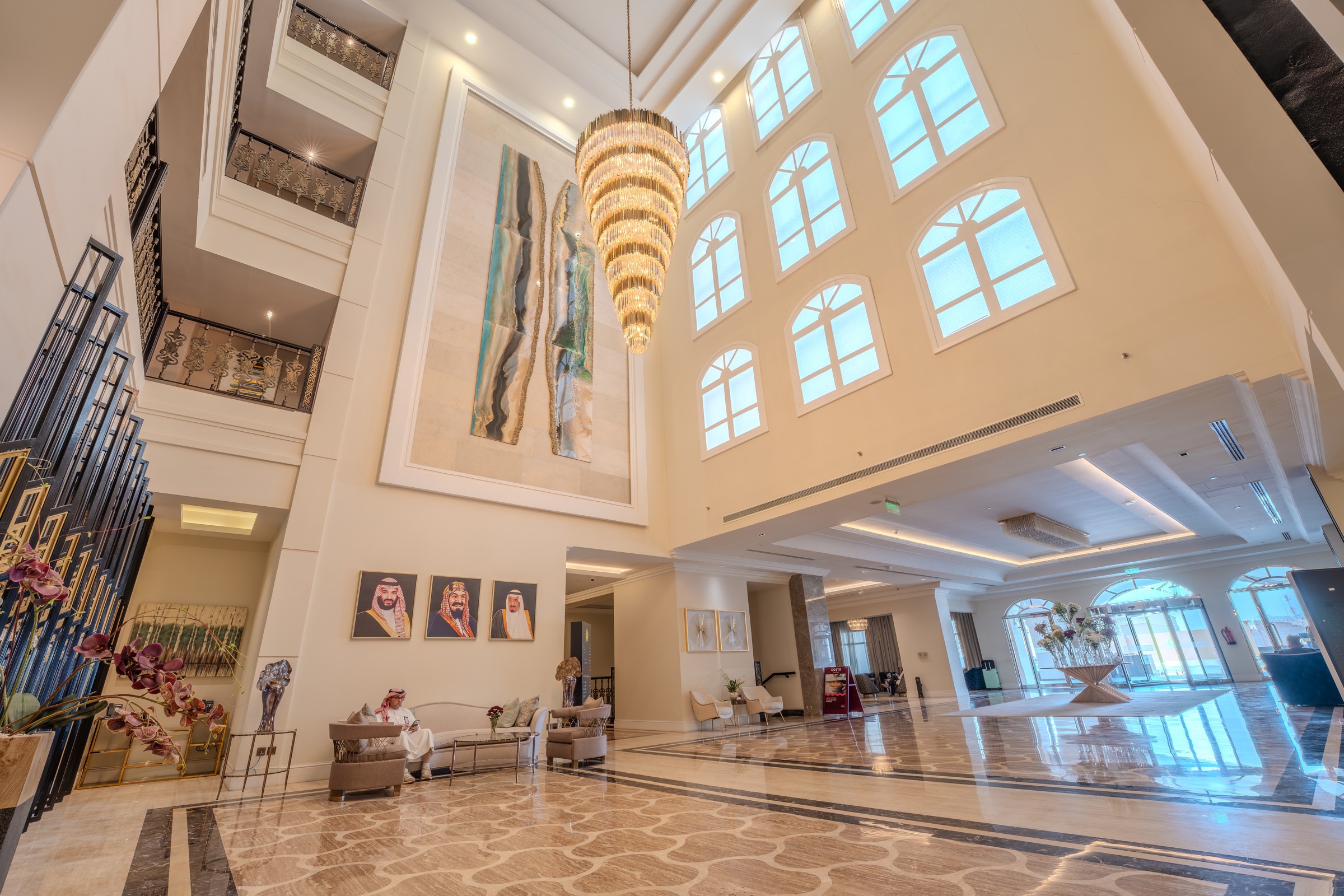 The lobby atrium rising the height of the building beneath its chandelier