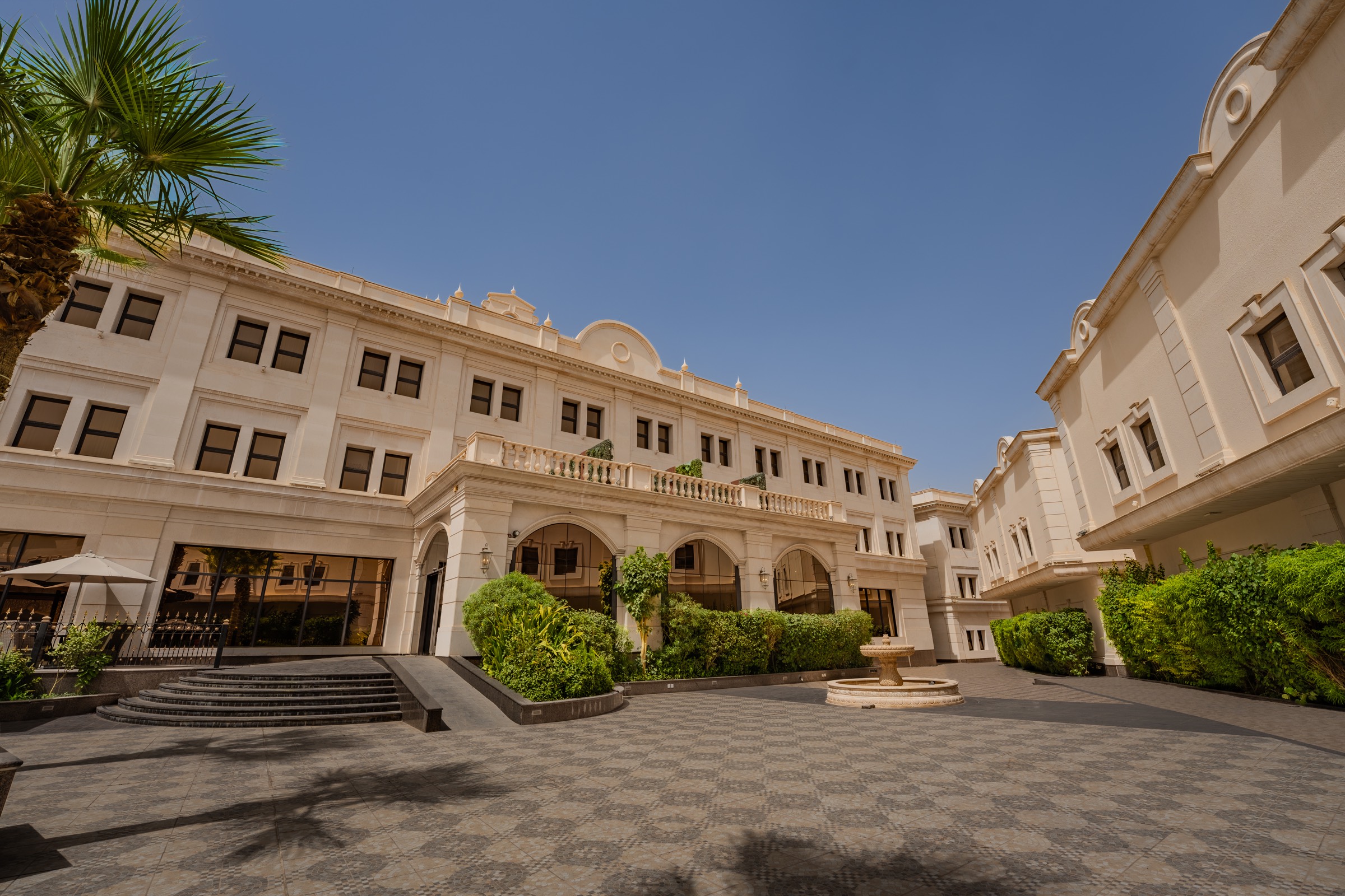 The courtyard between the wings, planted with palms