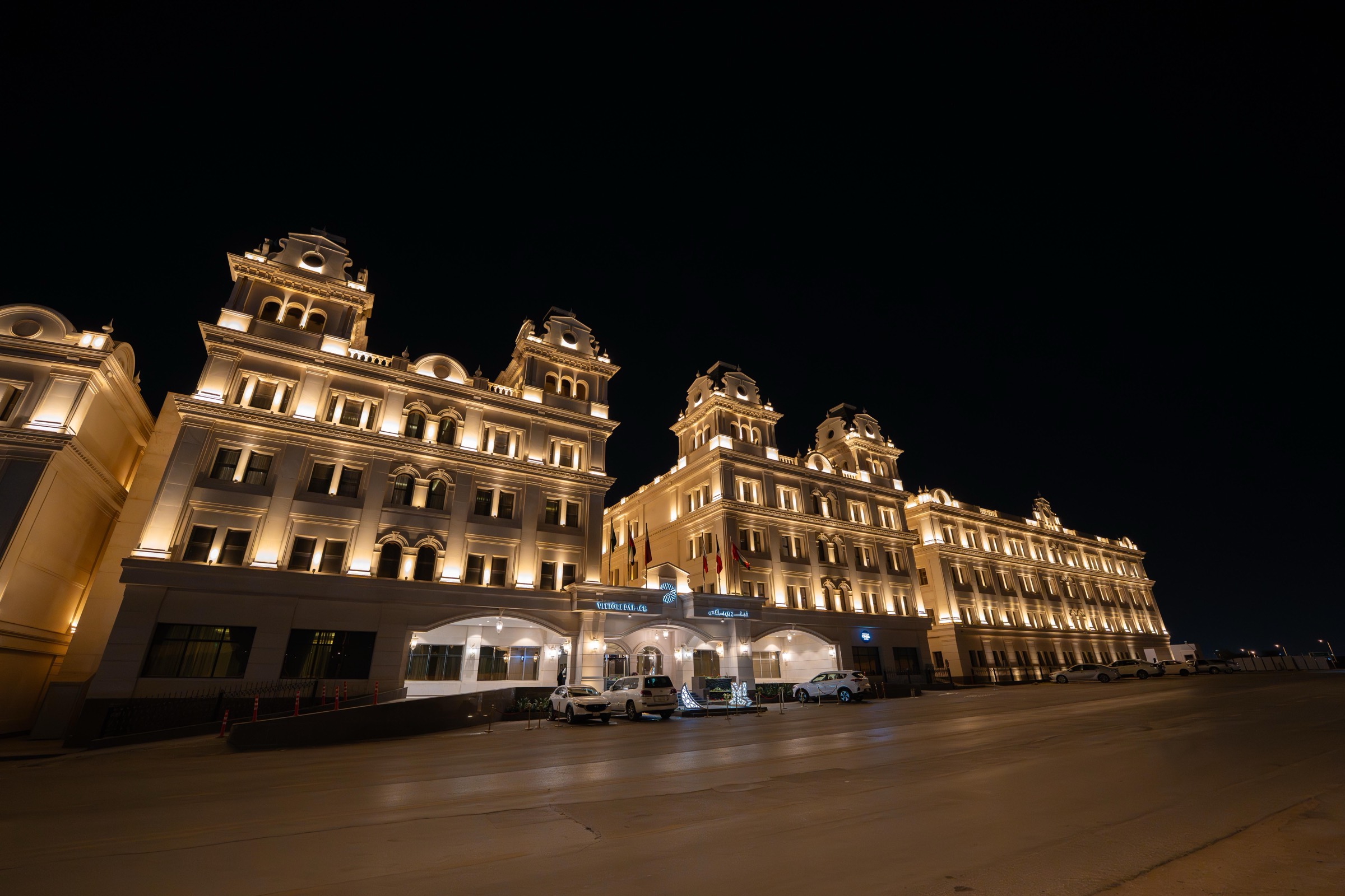 The palace facade floodlit against the night sky