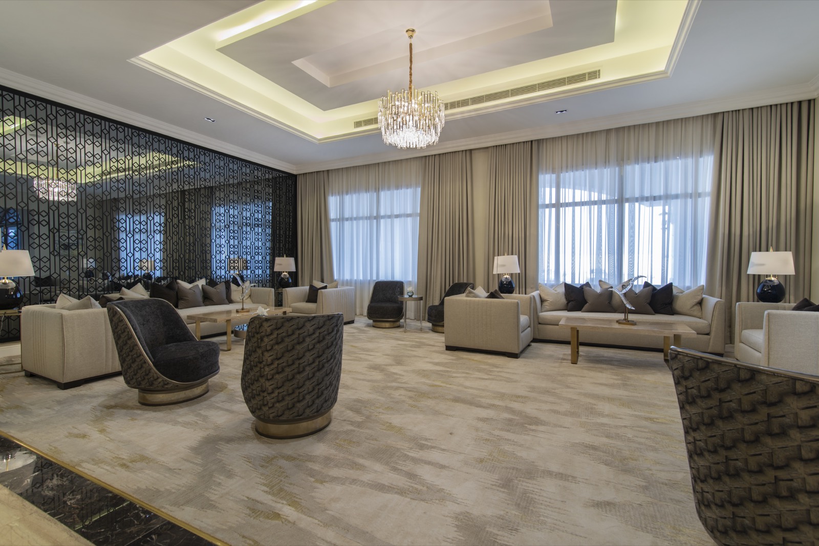 The Executive Suite living room, with its own seating beneath a chandelier